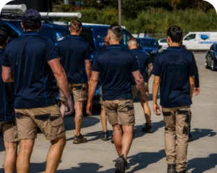 Plumbers walking to their service vans on a Waverley job